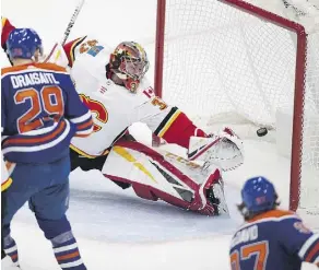  ?? GREG SOUTHAM ?? Calgary Flames goalie David Rittich tries in vain to stop a Connor McDavid shot, which ended up as the Oilers’ game-winner.