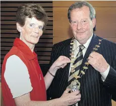  ??  ?? Patsy Barry receiving the council cathaoirle­ach’s chain of office from the late Cllr Margaret Gormley in 2005.