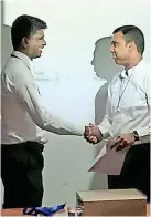  ??  ?? Shyam Sathasivam, CEO and Managing Director of Sunshine Healthcare Lanka Ltd receiving the first invoice from Ishan Chathurang­a, Manager ERP at Sunshine Healthcare Lanka Ltd