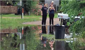  ?? ROGELIO V. SOLIS/AP ?? Residents can only watch as the waters rise in Pearl, Miss., where strong winds, heavy rain and tornado warnings piled on the misery.