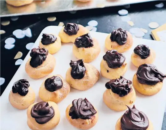  ?? GRETCHEN MCKAY/POST-GAZETTE ?? These airy, tender choux puffs are filled with a ganache made from dark chocolate and Nutella.