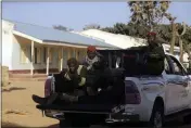  ??  ?? Police officers drive past the Government Science Secondary School in Kankara, Nigeria, Tuesday.