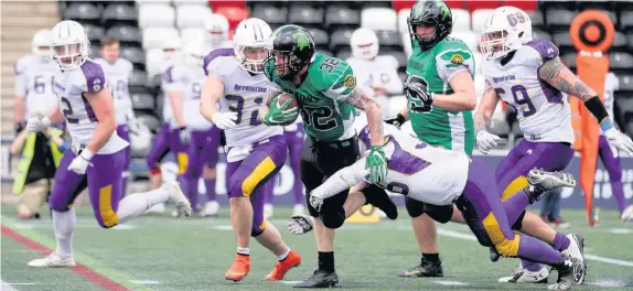  ?? Tim Furfie ?? Halton Spartans running back Craig Owen attempts to make a break upfield against the Shropshire Revolution in the teams’ clash at the Select Security Stadium on Sunday.