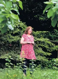 ??  ?? &gt; Julie Morgan, pictured yesterday in Rhodri’s beloved garden where he planted rare apple trees