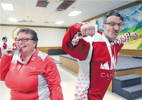  ?? MICHAEL BELL ?? Darlene MacQuarrie, director of programmin­g for Special Olympics Saskatchew­an, and athlete Chris Anderson show off the floor-hockey team’s silver medals at the Austrian Club on Wednesday. The team recently returned from the Special Olympics World...