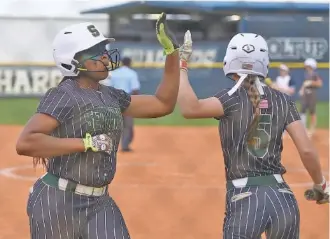  ?? STAFF PHOTO BY MATT HAMILTON ?? Silverdale Baptist Academy’s Jaliyah Whitaker, left, celebrates with Kennedy Stinson after scoring during Thursday’s softball game at Chattanoog­a Christian School.