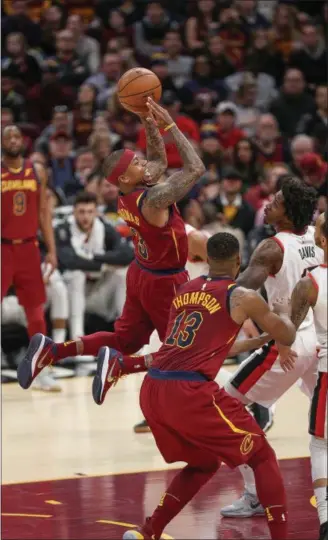  ?? TIM PHILLIS — THE NEWS-HERALD ?? Isaiah Thomas shoots as the Blazers’ Ed Davis defends Jan. 2. Thomas had 17 points in his Cavs debut in a 127-110 win.