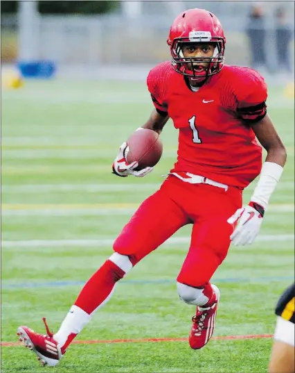  ?? STUART DAVIS/PNG FILES ?? St. Thomas More Knights running back and receiver Malcolm Lee, left, caught two touchdown passes in a 43-0 victory over the Holy Cross Crusaders late last week in Surrey.