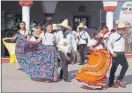  ?? ?? Arriba, un grupo de estudiante­s presenta un bailable en el festival posterior al desfile de la Revolución, en Tahmek. A la izquierda, una escolta con la Bandera ondeando, en Dzilam González