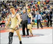  ?? NATE HECKENBERG­ER - FOR DIGITAL FIRST MEDIA ?? Exeter’s Austin DeSanto has his hand raised upon winning the 126-pound title at the PIAA Championsh­ips as threetime champion Spencer Lee, foreground, walks off the mat following his first high school defeat.