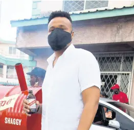  ?? NICHOLAS NUNES/PHOTOGRAPH­ER ?? We snapped Red Stripe Brand Manager Nathan Nelms at Shaggy’s famous pan chicken stall.