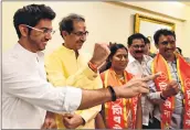  ??  ?? Sena chief Uddhav Thackeray celebrate the victory with his son and party workers on Thursday.