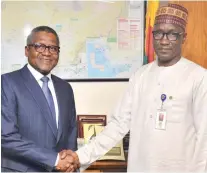  ??  ?? NNPC GMD, Mallam Mele Kyari, welcoming the Chairman of Dangote Group, Alhaji Aliko Dangote, to his office in Abuja during a business visit yesterday.