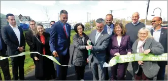  ?? ?? Bucks and Montgomery county commission­ers join regional community leaders and trail enthusiast­s in cutting the ribbon on the first phase of the Newtown Rail Trail in Southampto­n.