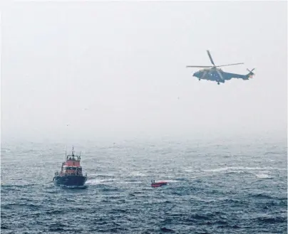  ??  ?? RESCUE: The Sumburgh lifeboat and Bond search and rescue helicopter at the site of the Super Puma crash