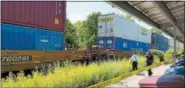  ?? PHOTO BY JOHN BECHTOLD ?? Emergency responders work alongside the stopped train in Midtown Kingston after Monday’s fatal incident.