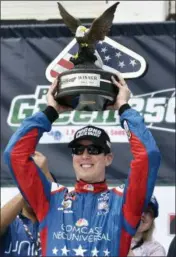  ?? DERIK HAMILTON — THE ASSOCIATED PRESS ?? Kyle Busch raises the trophy in Victory Lane after winning the NASCAR Xfinity Series auto race at Pocono Raceway, Saturday in Long Pond, Pa.