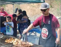  ?? Kyle Shannon/The Signal (See additional photos at signalscv.com) ?? Ken Harris, who griled for the First American 1031 Exchange, grills tri-tip and chicken at the 2018 Grill Master Challenge cook-off on Saturday at Wolf Creek Brewery.