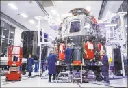  ?? Philip Pacheco / AFP via Getty Images ?? Employees of SpaceX work on the Crew Dragon reusable spacecraft at SpaceX headquarte­rs in Hawthorne, Calif.