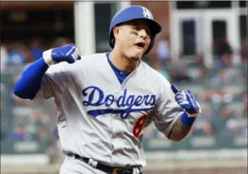  ?? JOHN BAZEMORE — THE ASSOCIATED PRESS ?? The Dodgers’ Manny Machado (8) celebrates his three-run homer against the Braves during the seventh inning in Game 4 of the National League Division Series Monday in Atlanta.