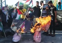  ?? (Mohammed Salem/Reuters) ?? PROTESTERS BURN images of US President Donald Trump and Prime Minister Benjamin Netanyahu in the Gaza Strip yesterday.