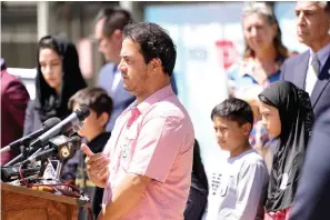  ?? The Associated Press ?? ■ Mohammad Faizi, center, speaks during a news conference Thursday in El Cajon, Calif. He and his family were visiting relatives in Afghanista­n in August and were forced to escape as the Taliban seized power. Faizi, a green card holder from the San Diego suburb of El Cajon, said he and his wife and five children were stopped by the Taliban at a checkpoint on their way to the airport. His wife is a U.S. citizen. Faizi, whose family got out just before the last U.S. flight left, said he was asked at the checkpoint why he was trying to leave Afghanista­n. “I told him, that’s our country. That’s my nation. We’re living there. So we have to get out of here.”