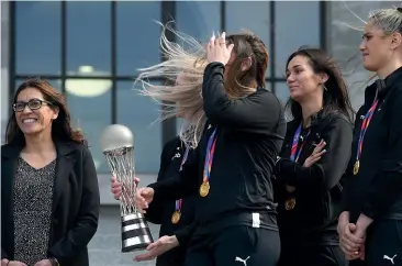  ?? GETTY IMAGES ?? 2019 Netball World Cup winners the Silver Ferns with coach Noeline Taurua, left, at Parliament yesterday.