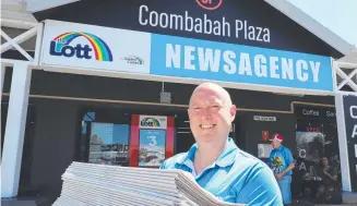  ??  ?? Coombabah Lakes News owner Adrian Lancaster with papers. Picture Glenn Hampson