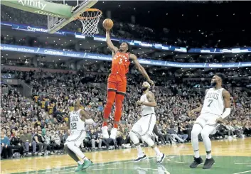  ?? WINSLOW TOWNSON/THE ASSOCIATED PRESS ?? Toronto Raptors forward OG Anunoby goes in for a dunk past Boston Celtics’ Terry Rozier (12), Marcus Morris and Jaylen Brown (7) during the second quarter of an NBA basketball game, in Boston on Sunday.