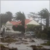  ?? PHOTOS BY THE ASSOCIATED PRESS ?? Debris blocks a road in the seafront village of Feteira, outside Horta, in the Portuguese island of Faial on Wednesday. Hurricane Lorenzo also lashed the Azores Islands with heavy rain, powerful winds and high waves.