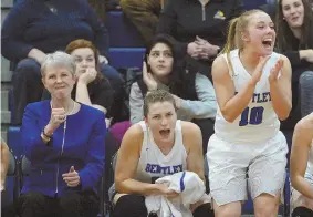  ?? STAFF PHOTOS BY CHRISTOPHE­R EVANS ?? GRAND EVENING: Bentley women’s basketball coach Barbara Stevens (left) pumps her fist as players Megan Lewis (center) and Amy McConnell celebrate during the Falcons’ win over Adelphi last night in Waltham which handed Stevens her 1,000th coaching...