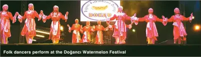  ??  ?? Folk dancers perform at the Doğancı Watermelon Festival