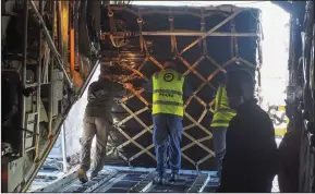 ?? (AP/New Zealand Defense Force) ?? Workers unload aid supplies from a Hercules aircraft Thursday at Fua’amotu Internatio­nal Airport near Nuku’alofa, Tonga.