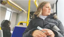  ?? WAYNE CUDDINGTON ?? Sarah Wright-Gilbert on board an LRT train: her critics have included the chair of the transit commission.