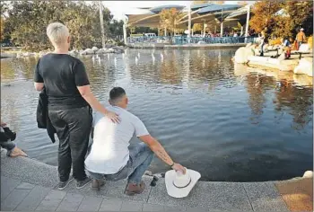  ?? Photograph­s by Al Seib Los Angeles Times ?? BRANDON GARZA is comforted by his mother, Lara Cornelius, at services Thursday dedicating a Healing Garden in Conejo Creek North Park in Thousand Oaks to victims of the Borderline shooting.