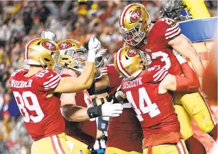  ?? ASHLEY LANDIS AP ?? 49ers running back Christian Mccaffrey (23) celebrates his winning rushing touchdown with teammates late in the second half.