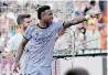  ?? ?? VINICIUS Junior reacts to being insulted, pointing at the stands at the Mestalla on Sunday. | AFP