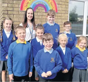 ??  ?? Huncoat deputy headteache­r Lisa McCloskey with pupils celebratin­g their ‘good’ Ofsted inspection result.