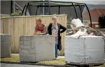  ?? PHOTO: ROBERT KITCHIN/STUFF ?? Blair and Louise Ansell with the two-tonne concrete blocks that will prevent another car crashing into their Lower Hutt property.