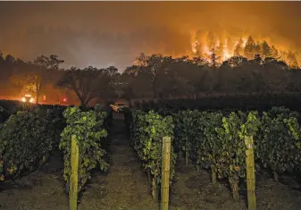  ?? Carlos Avila Gonzalez / The Chronicle 2020 ?? The Glass Fire burns at Vineyard 29, between St. Helena and Calistoga, in September 2020. During fire season, wineries can’t afford soaring insurance rates or have seen policies dropped.