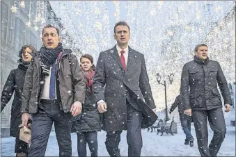  ?? [EVGENY FELDMAN/NAVALNY CAMPAIGN] ?? Russian opposition leader Alexei Navalny, center, heads to a meeting Monday of the Central Election Commission in Moscow. Twelve of the 13 members of the commission rejected his bid to run for president against Vladimir Putin.