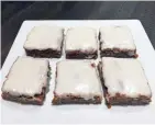  ??  ?? Gingerbrea­d bars are chewy and sweet, topped with a powdered sugar glaze.