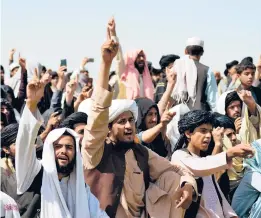  ?? JAVED TANVEER/GETTY-AFP ?? Taliban supporters gather Wednesday in Kandahar to celebrate the U.S. withdrawal of all its troops out of Afghanista­n following the Talibans military takeover.