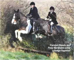  ??  ?? Carolyn Woods and Posy Abrahams jump
a hedge together