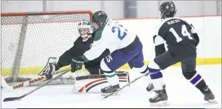  ?? PHOTO BY DARNELL MARBURY ?? LaPax’s Derek McKee and Stone goaltender Garrett Cherry reach for the puck as Stone defender Garrett Hayes moves in to help defend in Friday’s contest at Capital Clubhouse in Waldorf. McKee scored in the contest as the teams skated to a 3-3 tie.