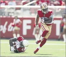  ?? NHAT V. MEYER — STAFF PHOTOGRAPH­ER ?? The 49ers’ Matt Breida breaks a tackle Sunday against the Cardinals’ Antoine Bethea at Levi’s Stadium. Breida exited the game after the first quarter after injuring his ankle.