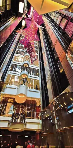  ??  ?? The interior of Harmony Of The Seas is nothing short of a six- star hotel experience, replete with bubble elevators.