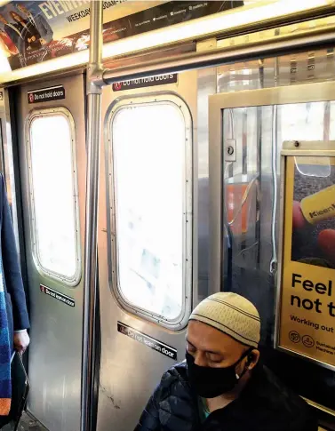  ??  ?? DOES THIS TRAIN STOP AT CITY HALL?: New York mayoral candidate Andrew Yang rides the subway after greeting supporters in Brooklyn on March 3, 2021.