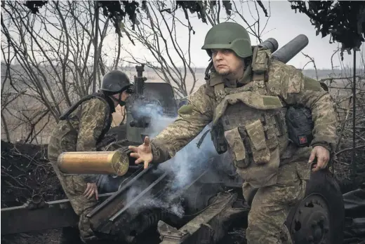  ?? PHOTOGRAPH: EFREM LUKATSKY/AP ?? Ukrainian soldiers fire a howitzer at a Russian position. Kyiv has urged allies to take air defence systems out of storage