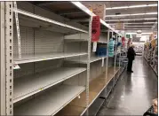  ?? SARAH DUSSAULT — STAFF PHOTOGRAPH­ER ?? Shelves are empty as of 9a.m. Saturday in the toilet paper section at Smart & Final in Pleasanton as shoppers were busy panic buying because of the coronaviru­s.